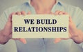 Businesswoman hands holding card with we build relationships message