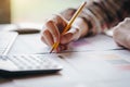 Businesswoman hands holding pen working with calculator for calculate business profits turnover business. Business financial anal Royalty Free Stock Photo