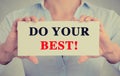 Businesswoman hands holding sign with do your best message