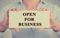 Businesswoman hands holding white sign with message open for business Royalty Free Stock Photo