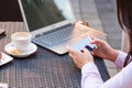 Businesswoman hands with laptop and mobile phone during breakfast. Royalty Free Stock Photo