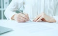 Businesswoman hands sign contract on desk. Female entrepreneur puts signature on official agreement. Profitable deal Royalty Free Stock Photo