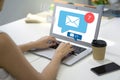 Businesswoman hands typing on laptop computer keyboard surfing internet on office table with email icon, email marketing concept, Royalty Free Stock Photo