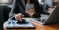 Businesswoman hands working with finances about cost and calculator and laptop with tablet, smartphone at office Royalty Free Stock Photo