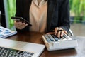 Businesswoman hands working with finances about cost and calculator and laptop with tablet, smartphone at office Royalty Free Stock Photo