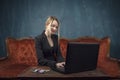 Businesswoman, happy woman in suit smiling using laptop for work in vintage interior