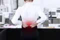 Businesswoman having back pain at office Royalty Free Stock Photo