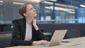 Businesswoman having Neck Pain while Typing on Laptop Royalty Free Stock Photo