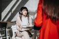 Businesswoman in headphones engaged in serious conversation at outdoor cafe. Royalty Free Stock Photo