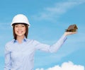 Businesswoman in helmet holding house on palm Royalty Free Stock Photo