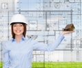 Businesswoman in helmet holding house on palm Royalty Free Stock Photo