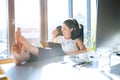 Businesswoman in her office sitting with legs on desk. Royalty Free Stock Photo