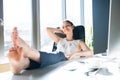 Businesswoman in her office sitting with legs on desk. Royalty Free Stock Photo