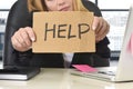 Businesswoman in her 40s holding help sign desparate suffering stress overworked