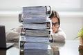 Businesswoman Hiding Behind The Folders Stack