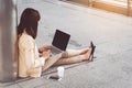 Businesswoman in high heels sitting on floor with computer in he Royalty Free Stock Photo