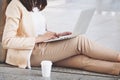 Businesswoman in high heels sitting on floor with computer Royalty Free Stock Photo