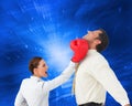 Businesswoman hitting a businessman with boxing gloves Royalty Free Stock Photo