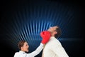 Businesswoman hitting a businessman with boxing gloves Royalty Free Stock Photo