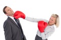 Businesswoman hitting colleague with her boxing gloves Royalty Free Stock Photo