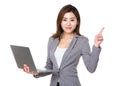 Businesswoman hold with notebook computer and finger point up Royalty Free Stock Photo