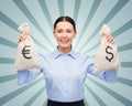 Businesswoman holding bags with dollar and euro Royalty Free Stock Photo