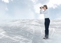 Businesswoman holding binoculars in sea of documents under sky clouds Royalty Free Stock Photo