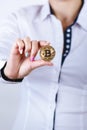 Businesswoman holding bitcoin isolated on a white background.Golden bitcoin coins in women`s hands. Virtual currency. Royalty Free Stock Photo
