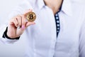 Businesswoman holding bitcoin isolated on a white background.Golden bitcoin coins in women`s hands. Virtual currency. Royalty Free Stock Photo