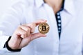 Businesswoman holding bitcoin isolated on a white background.Golden bitcoin coins in women`s hands. Virtual currency. Royalty Free Stock Photo