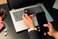 Businesswoman holding a black credit card and using the phone for make transactions online with the laptop. Concept teleworking Royalty Free Stock Photo