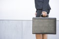 Businesswoman holding briefcase outdoors Royalty Free Stock Photo