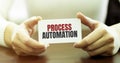 Businesswoman holding a card with text PROCESS AUTOMATION Royalty Free Stock Photo