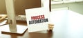 Businesswoman holding a card with text PROCESS AUTOMATION Royalty Free Stock Photo
