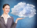 Businesswoman holding cloud with different digital icons.