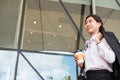 Businesswoman holding coffee outside office building. beautiful Royalty Free Stock Photo