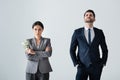 Businesswoman holding dollars near arrogant businessman standing with hands in pockets