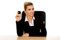 Businesswoman holding eight billiard ball by a desk Royalty Free Stock Photo