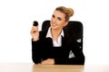 Businesswoman holding eight billiard ball by a desk Royalty Free Stock Photo