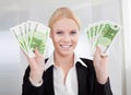 Businesswoman holding euro currency notes