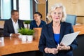 Businesswoman Holding File At Reception Counter