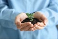 Businesswoman holding green seedling with soil, closeup Royalty Free Stock Photo