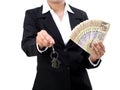 Businesswoman holding house key and currency Royalty Free Stock Photo