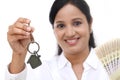 Businesswoman holding house key and currency notes Royalty Free Stock Photo