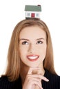 Businesswoman holding house model on head Royalty Free Stock Photo