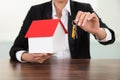 Businesswoman holding house model and keys Royalty Free Stock Photo