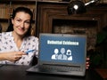 BusinessWoman holding a laptop. Business concept about Rebuttal Evidence with phrase on the sheet