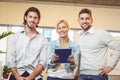Businesswoman holding laptop standing with male colleagues Royalty Free Stock Photo