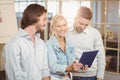 Businesswoman holding laptop standing with male colleagues Royalty Free Stock Photo