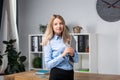 Businesswoman Holding Large File. young womanl standing in the office and holding folder. Portrait of young office worker holding Royalty Free Stock Photo